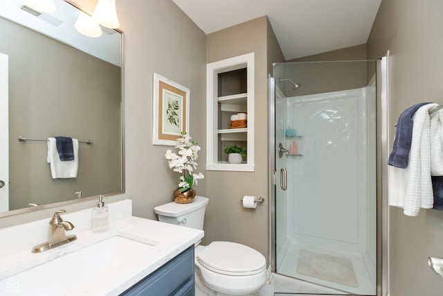 bathroom featuring vanity, a shower with door, and toilet