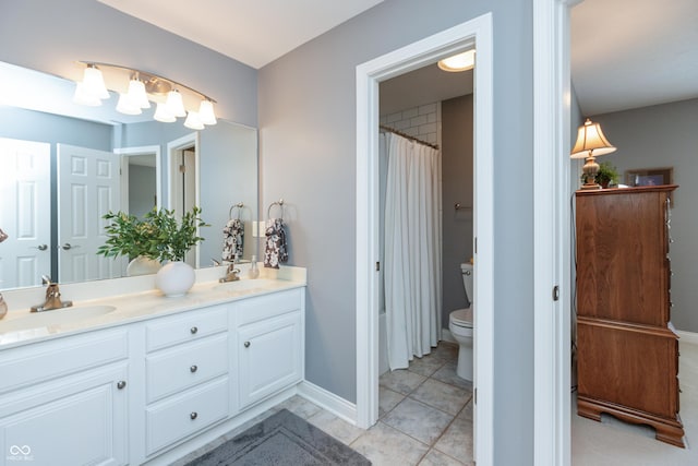 bathroom featuring tile patterned flooring, vanity, and toilet