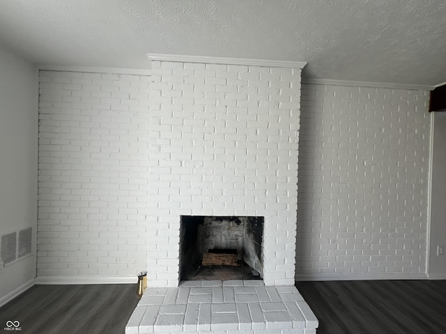 interior details featuring hardwood / wood-style flooring, a fireplace, crown molding, and a textured ceiling