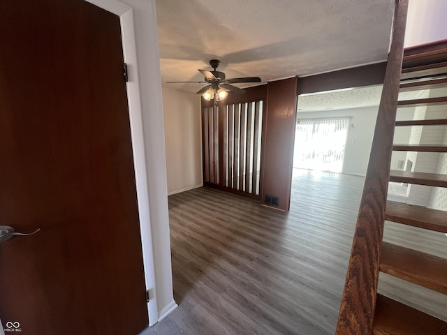 spare room with ceiling fan, hardwood / wood-style floors, and a textured ceiling