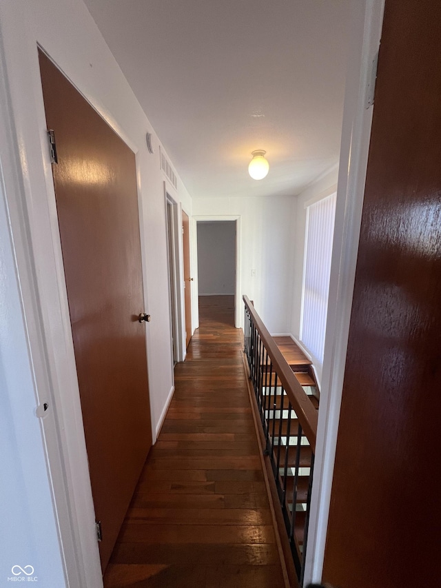 corridor featuring dark hardwood / wood-style floors