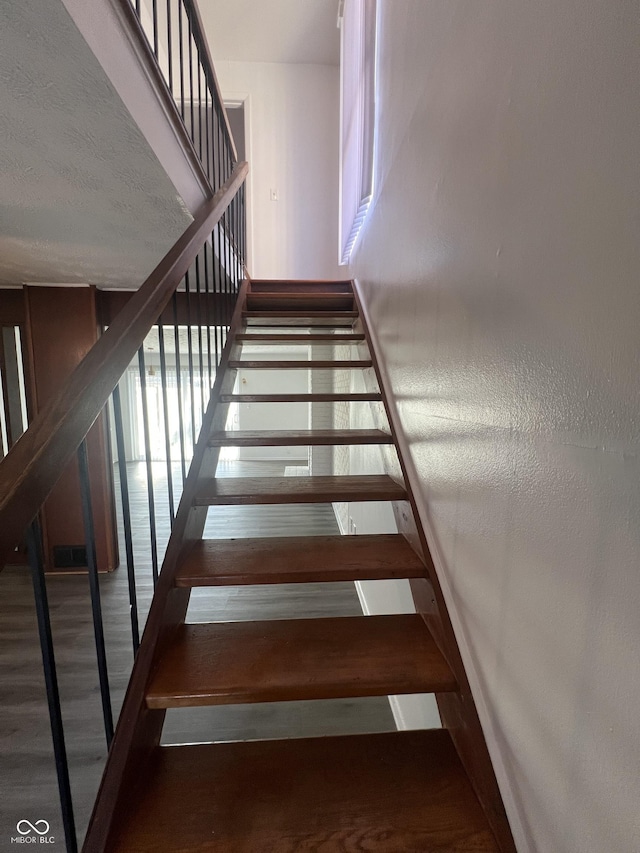 staircase featuring hardwood / wood-style flooring