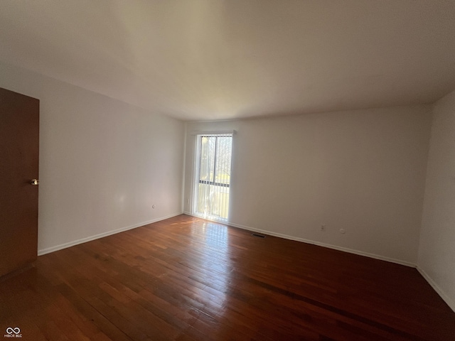 empty room featuring dark hardwood / wood-style flooring