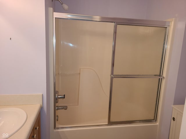 bathroom featuring vanity and bath / shower combo with glass door