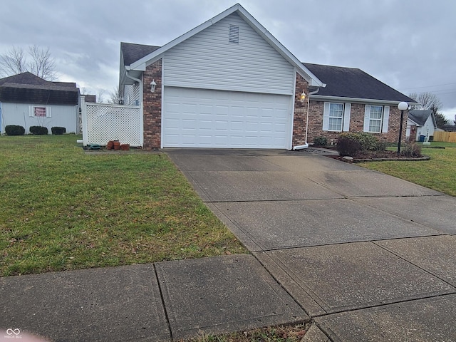 view of front of property with a garage and a front lawn