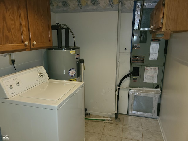 washroom featuring water heater, light tile patterned flooring, cabinets, and washer / dryer