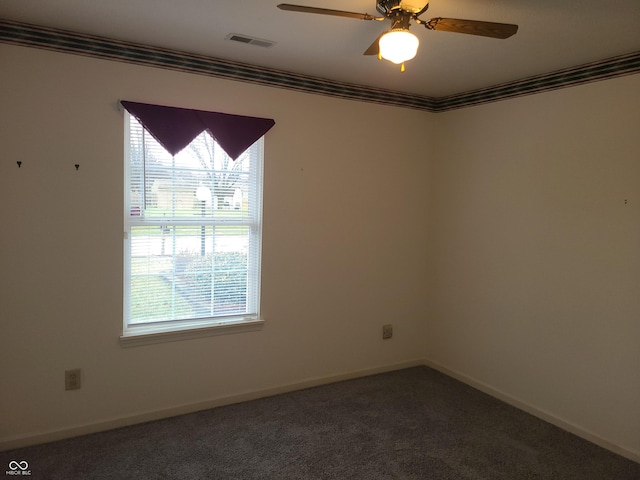 carpeted empty room featuring plenty of natural light, crown molding, and ceiling fan