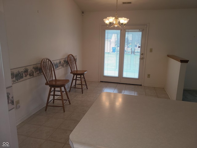 doorway to outside featuring light tile patterned floors and a chandelier