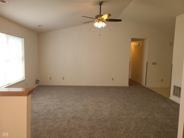 carpeted empty room featuring ceiling fan and lofted ceiling