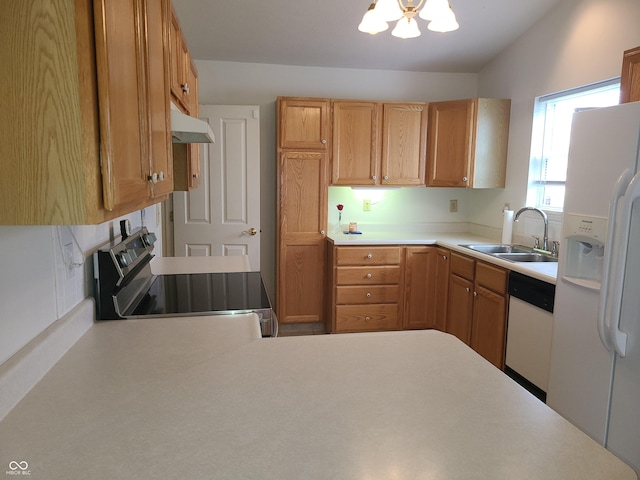 kitchen with white appliances, sink, and a chandelier