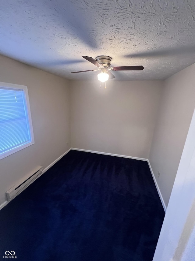 unfurnished room with a textured ceiling, a baseboard radiator, and ceiling fan