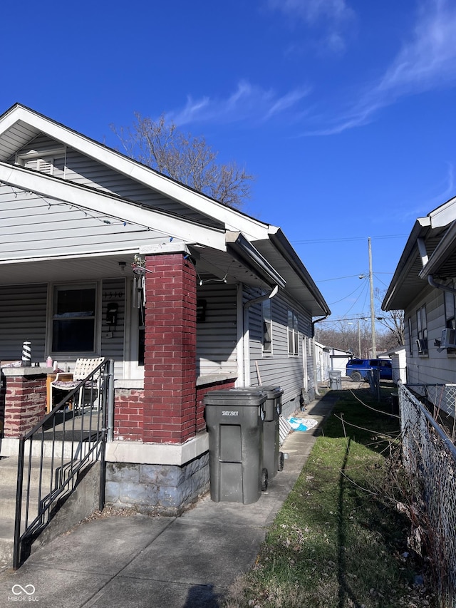 view of side of home with covered porch