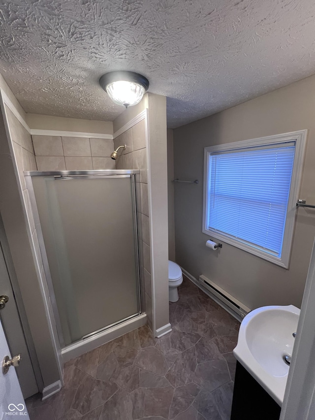 bathroom featuring a textured ceiling, a baseboard radiator, a shower with shower door, and toilet