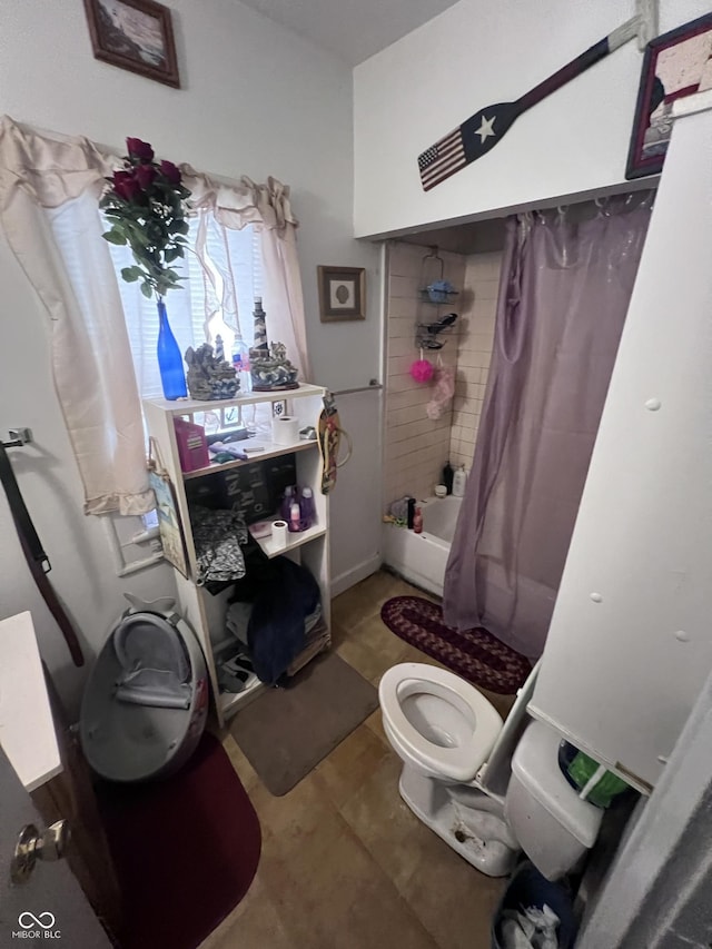 bathroom with toilet and shower / tub combo