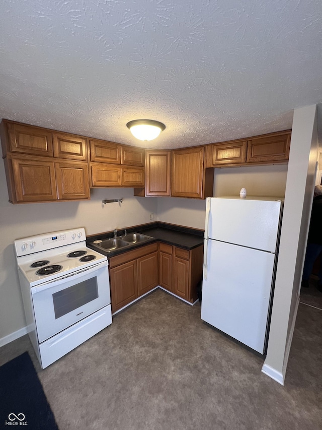 kitchen with a textured ceiling, dark carpet, white appliances, and sink