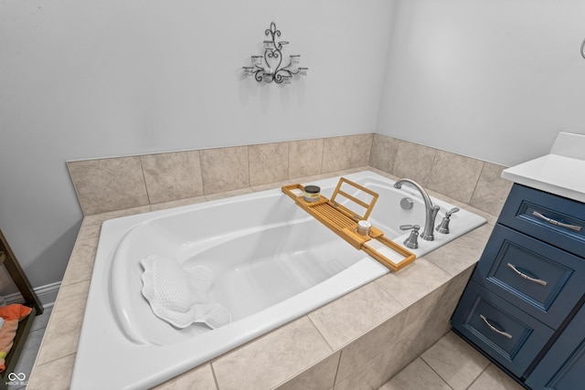 full bath featuring tile patterned floors, a garden tub, and vanity