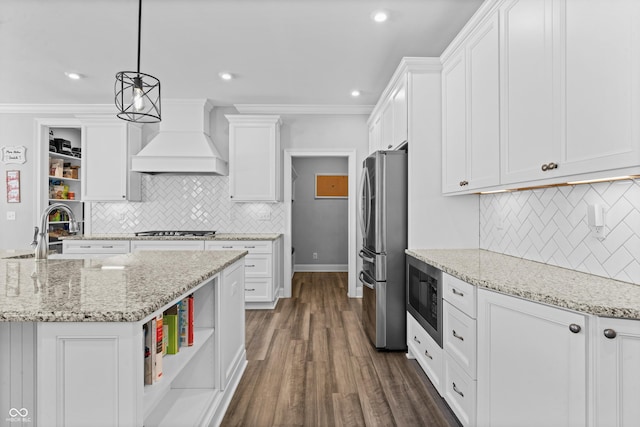 kitchen featuring stainless steel appliances, white cabinetry, hanging light fixtures, and custom exhaust hood