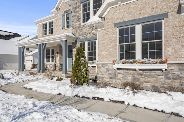 view of snow covered property entrance