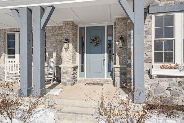 view of snow covered property entrance