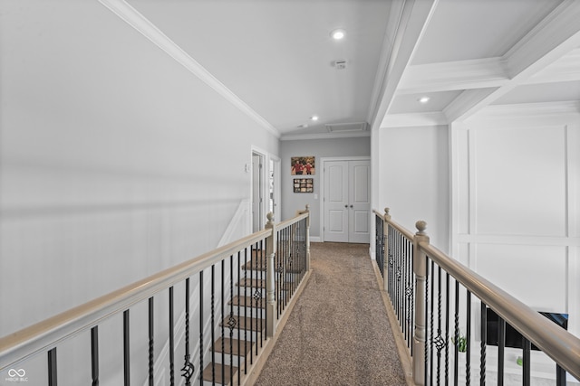 corridor with beamed ceiling, crown molding, carpet, and coffered ceiling