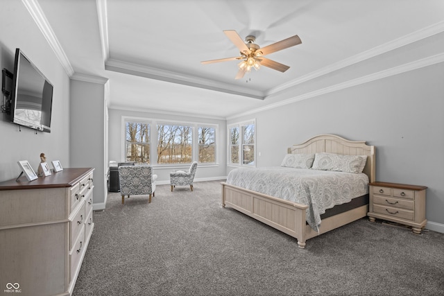 bedroom with dark carpet, baseboards, crown molding, and a tray ceiling