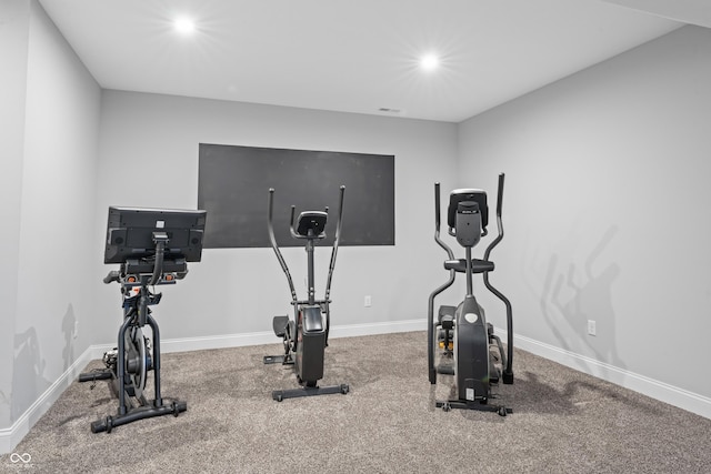 workout area featuring recessed lighting and baseboards