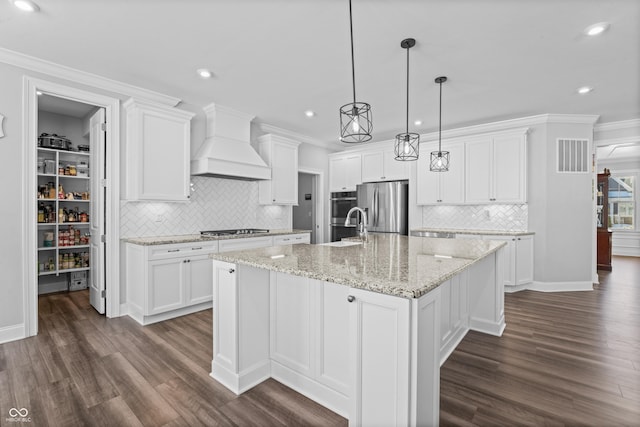 kitchen with stainless steel appliances, white cabinetry, a large island, and custom exhaust hood