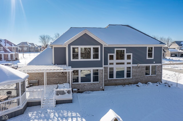 snow covered property with a deck