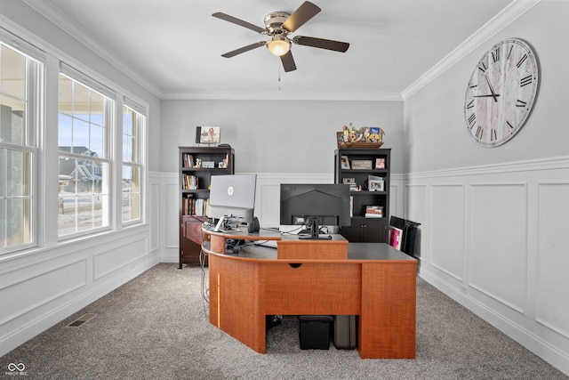 office space featuring crown molding, a decorative wall, visible vents, and ceiling fan