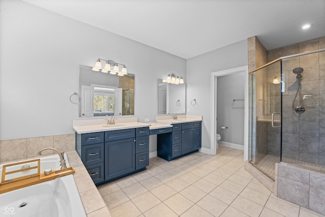 bathroom featuring tile patterned floors, a stall shower, toilet, and a sink