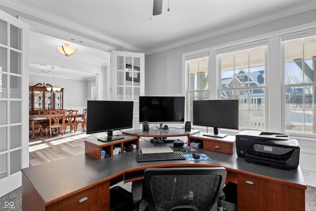 office area with light wood-type flooring, french doors, ceiling fan with notable chandelier, and crown molding