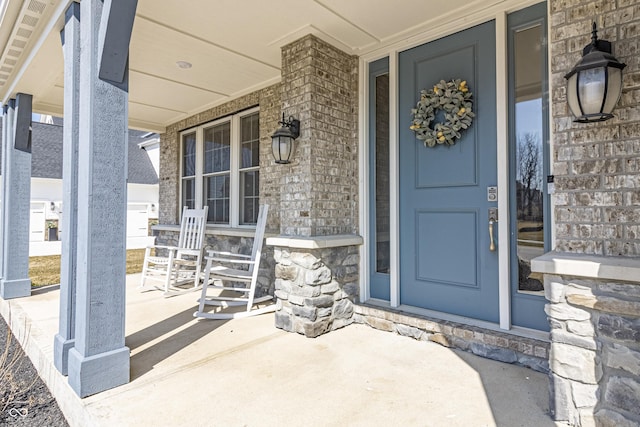 property entrance with stone siding and covered porch