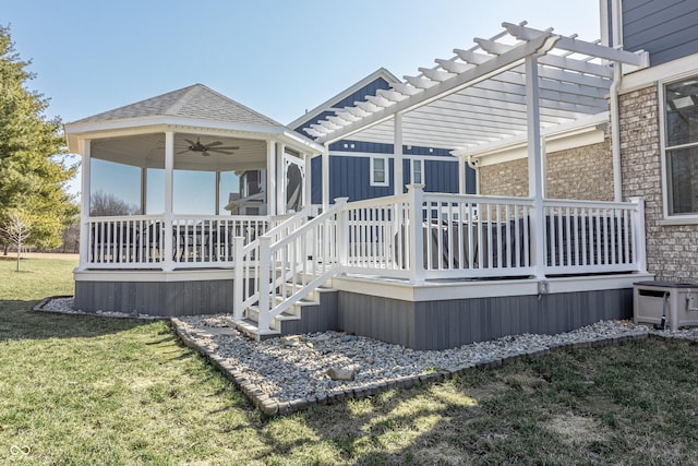 deck with a lawn, ceiling fan, and a pergola