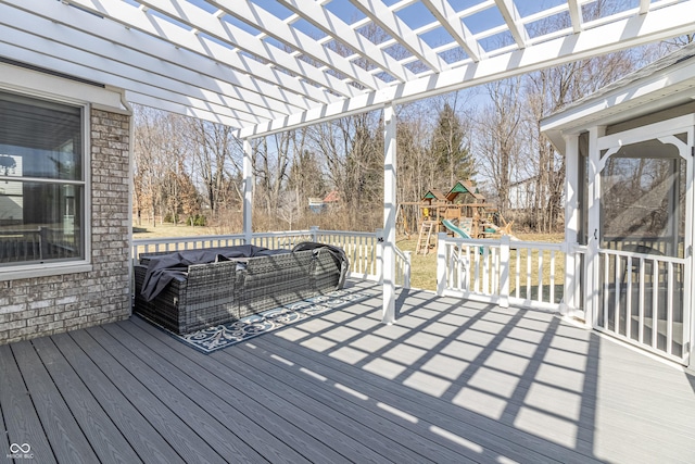 wooden terrace featuring an outdoor living space, a pergola, and a playground