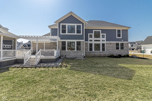 rear view of house featuring a wooden deck, brick siding, a lawn, and a pergola