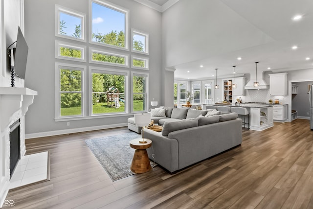 78 Chatham Brook Dr, Westfield, IN 46074 - living area with recessed lighting, a fireplace with flush hearth, ornamental molding, baseboards, and dark wood finished floors