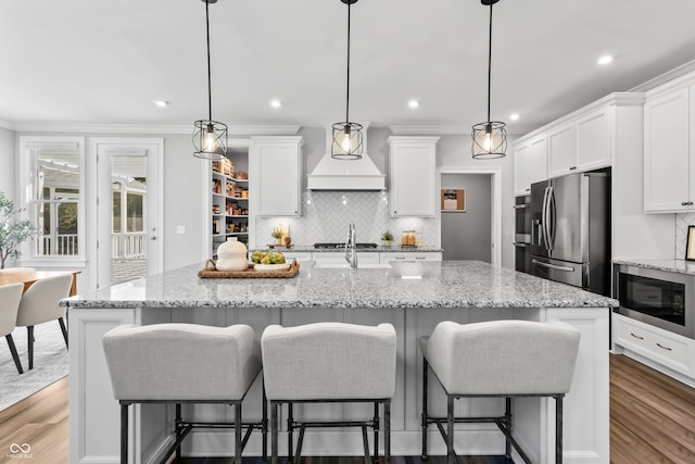 78 Chatham Brook Dr, Westfield, IN 46074 - kitchen featuring custom exhaust hood, stainless steel fridge with ice dispenser, built in microwave, wood finished floors, and recessed lighting
