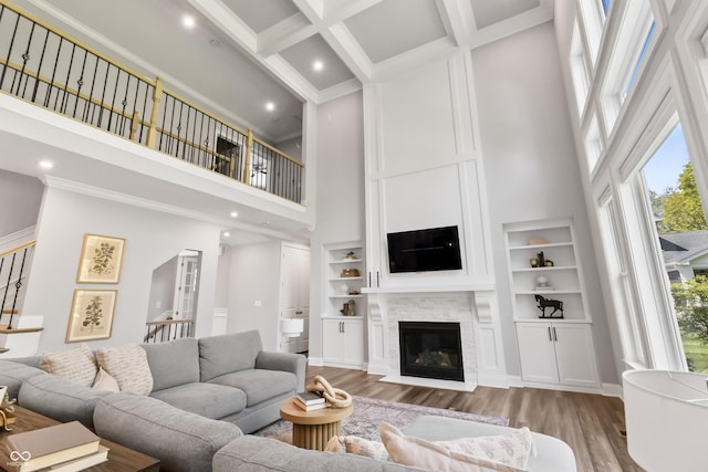 78 Chatham Brook Dr, Westfield, IN 46074 - living area featuring a towering ceiling, wood finished floors, a fireplace with flush hearth, built in features, and beamed ceiling