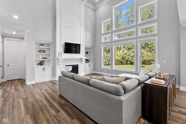 78 Chatham Brook Dr, Westfield, IN 46074 - living room with a towering ceiling, baseboards, plenty of natural light, wood finished floors, and a glass covered fireplace