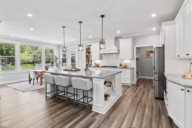78 Chatham Brook Dr, Westfield, IN 46074 - kitchen featuring appliances with stainless steel finishes, custom range hood, open shelves, white cabinetry, and decorative backsplash