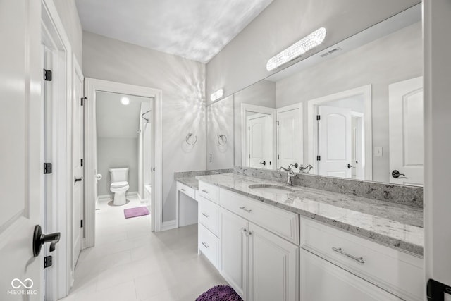 bathroom featuring vanity, toilet, and tile patterned flooring