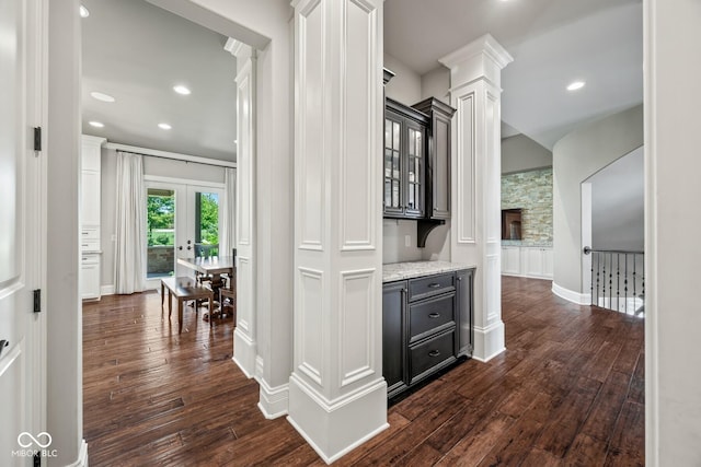 hallway featuring french doors, dark hardwood / wood-style floors, and decorative columns