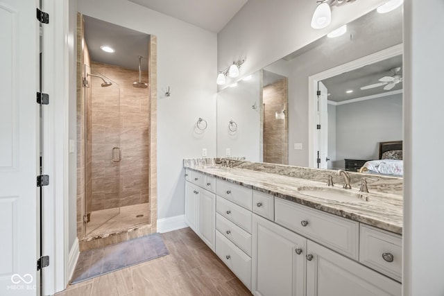 bathroom with vanity, ceiling fan, and walk in shower