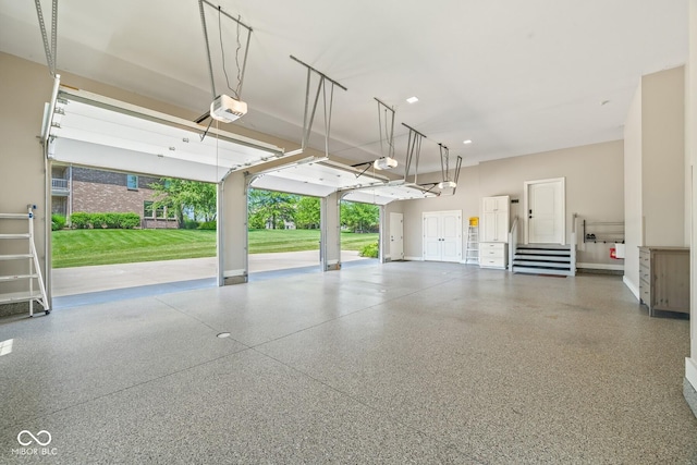 garage with a garage door opener and a lawn