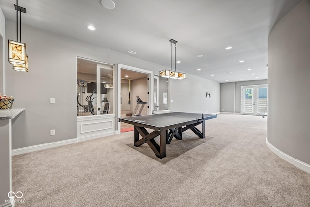 recreation room with light colored carpet and french doors