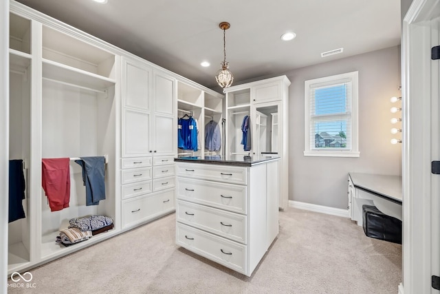 spacious closet featuring light carpet