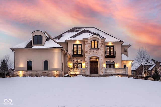 french country inspired facade featuring a porch