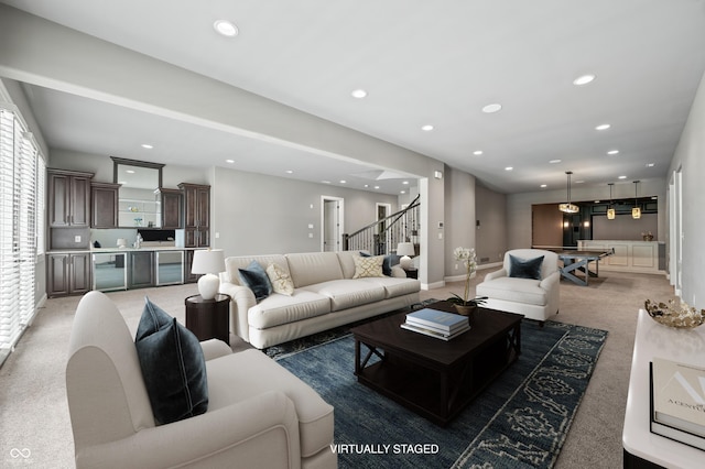 carpeted living room featuring sink and beverage cooler