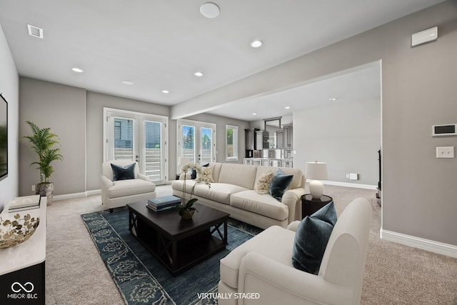 living room with french doors and carpet flooring