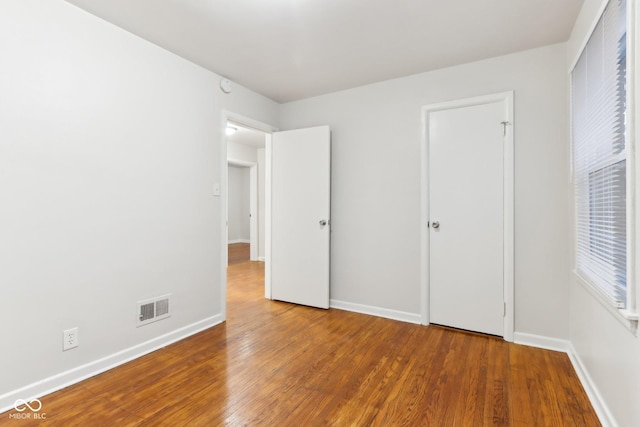 unfurnished bedroom with hardwood / wood-style floors